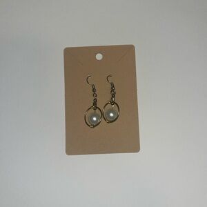 Gold handmade earrings with a pearl center